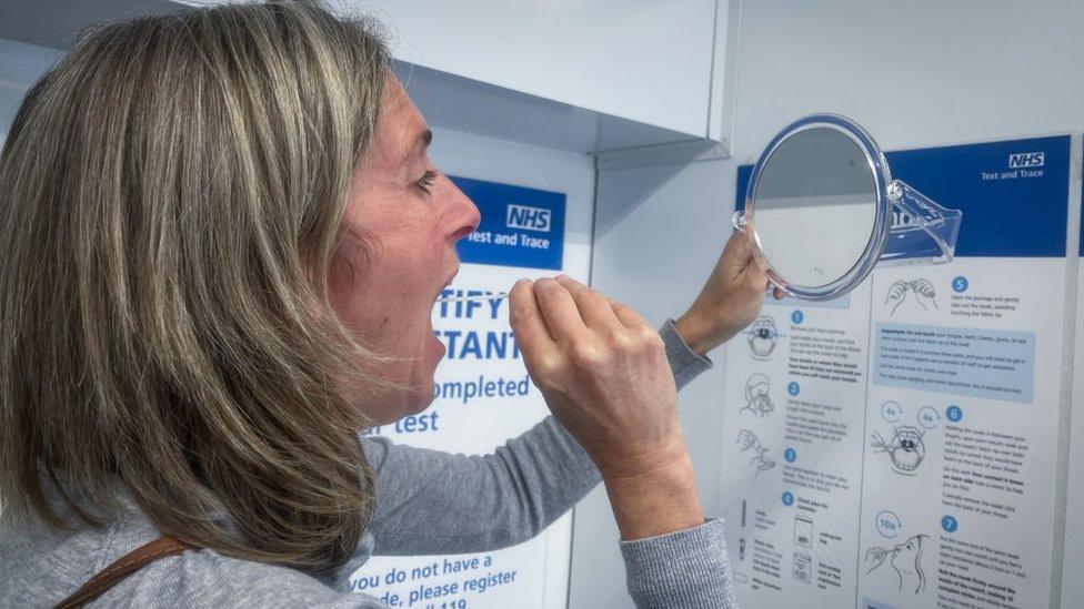 A woman takes a PCR test