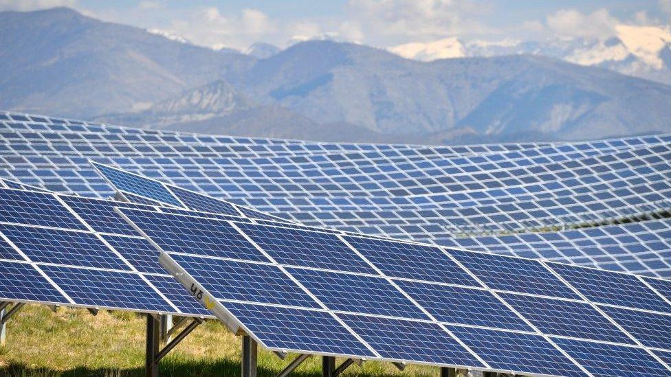 solar power station with mountains in background