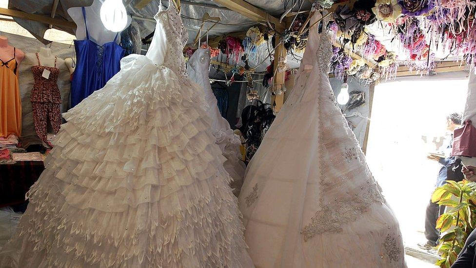 Wedding gowns in a stall in the northern Jordanian Zaatari refugee camp