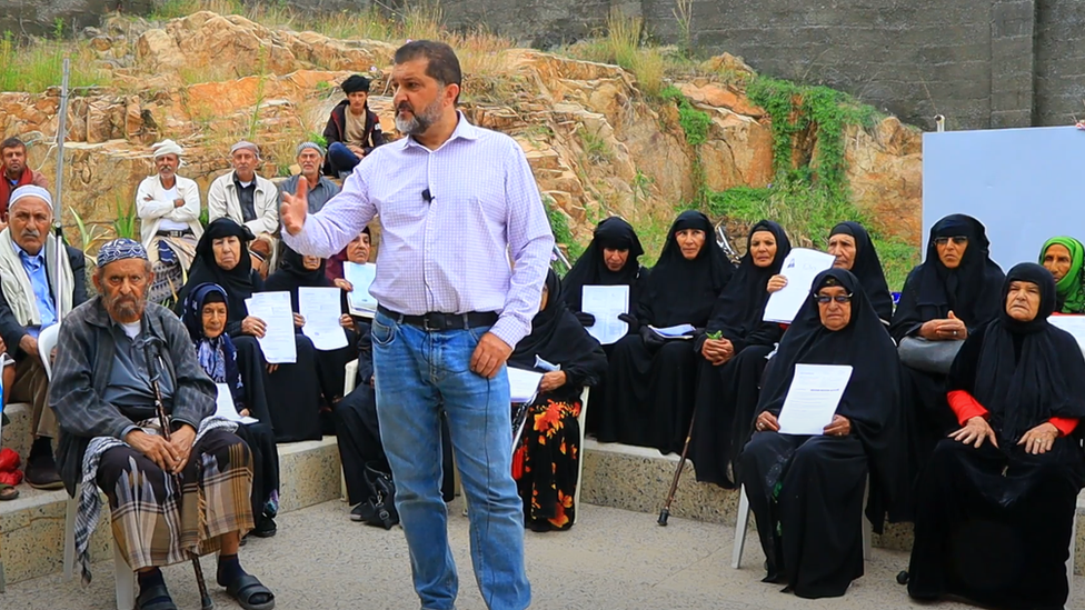 Ragih Muflihi with pensioners