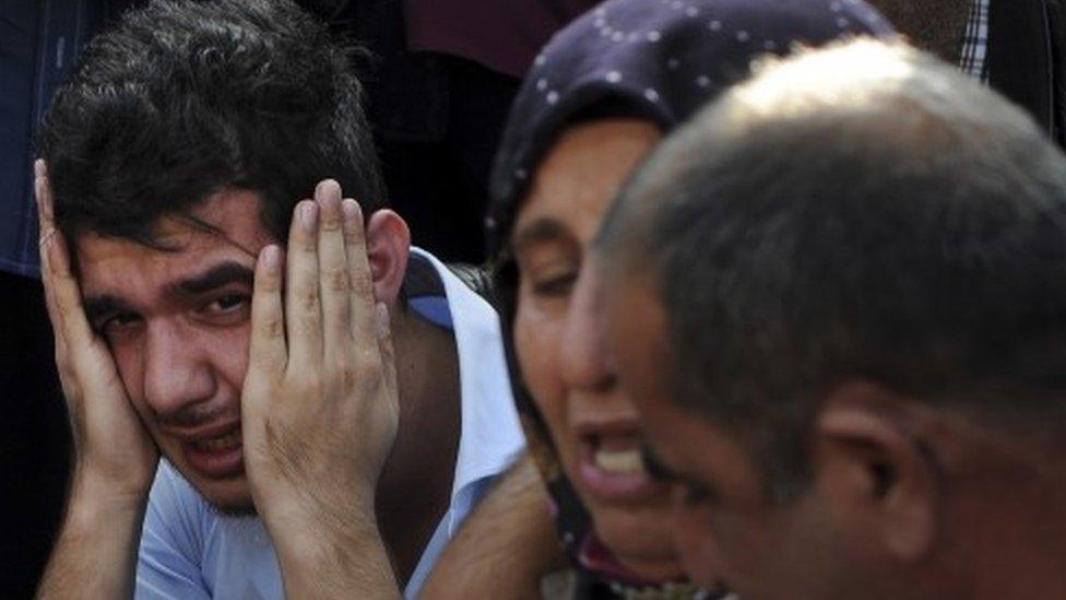 Relatives of people wounded at the explosions in Ankara, Turkey, react as they wait news for their loved ones outside a hospital (10 October 2015)