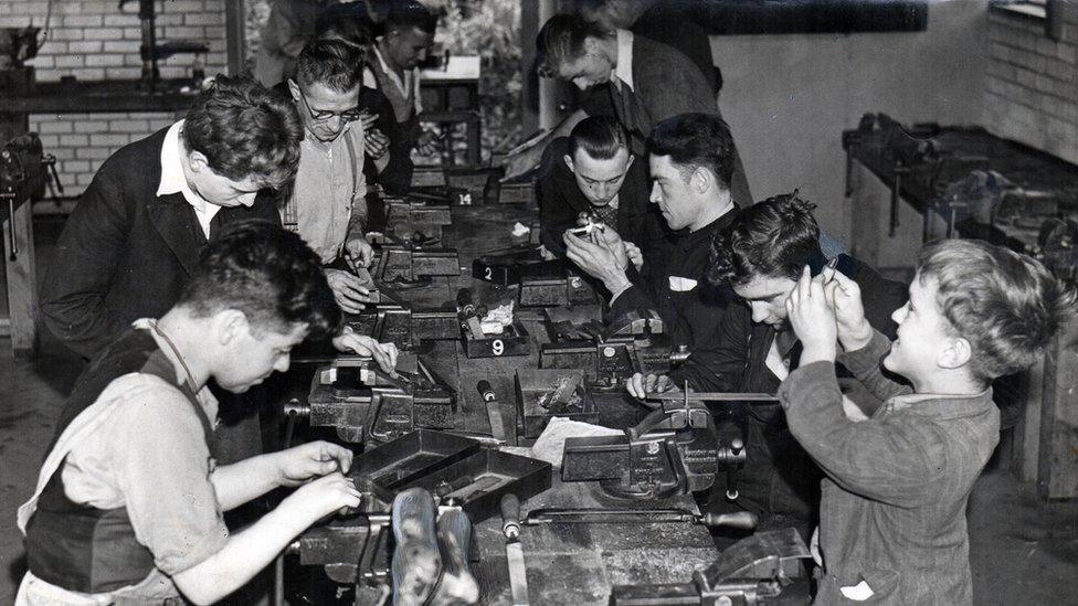 Large group doing woodwork 1930s