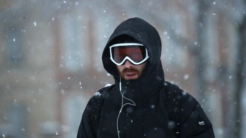 A commuter wearing ski goggles.