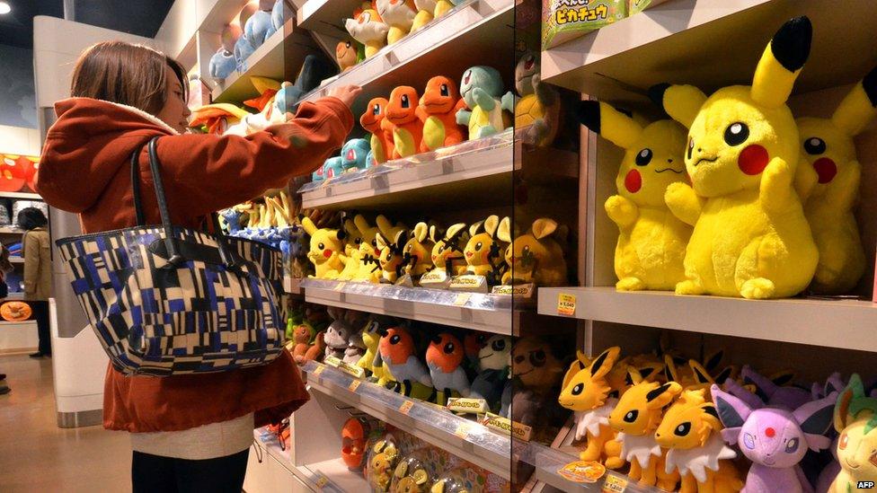 A customer looks at stuffed Pokemon dolls, a media franchise published and owned by Japanese videogame manufacturer Nintendo, at a Pokemon shop in Tokyo on January 29, 2014.