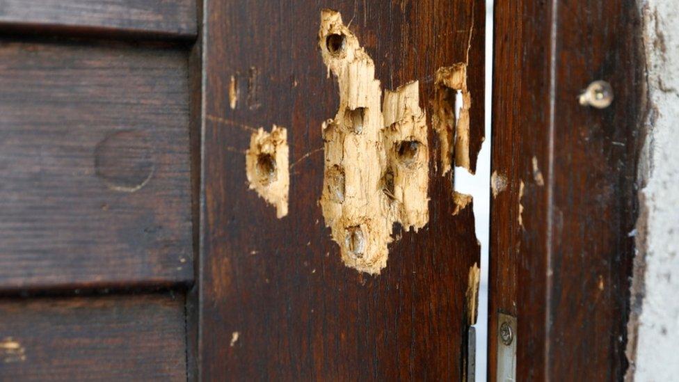 Bullet holes are seen in the door of a synagogue in Halle, Germany, July 28, 2020