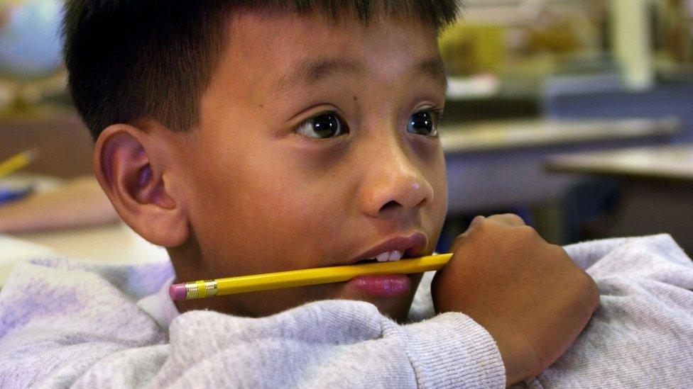 Boy with pencil in his mouth