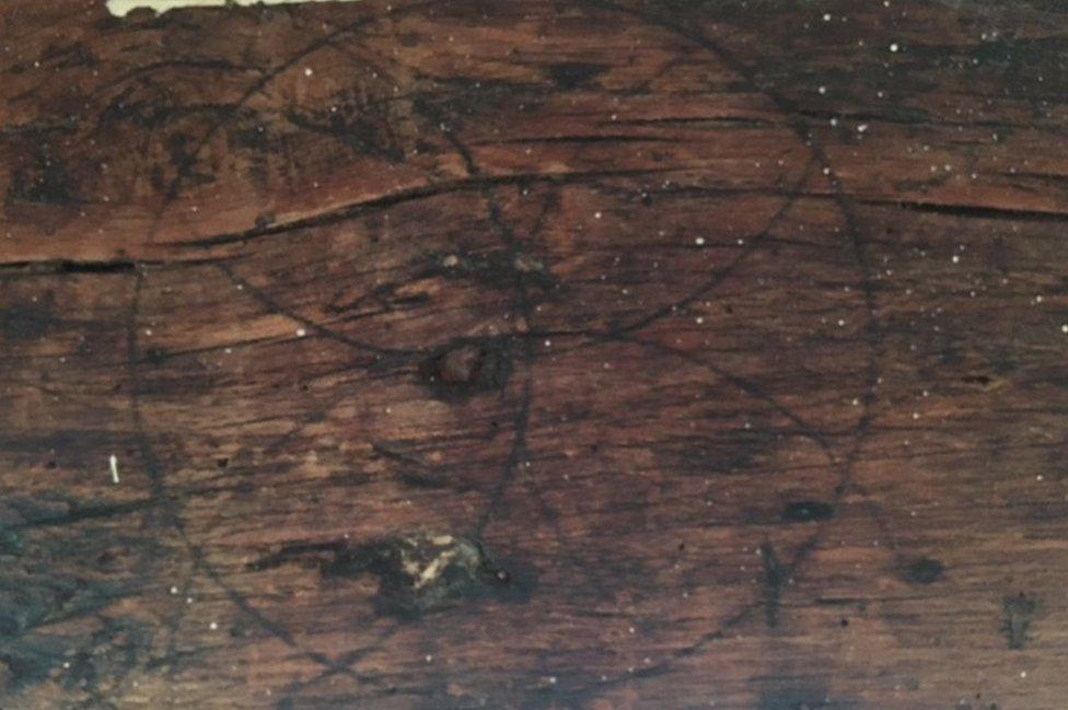 What appears to be a "Daisy Wheel" carved into wood, supposedly to entrap evil spirits