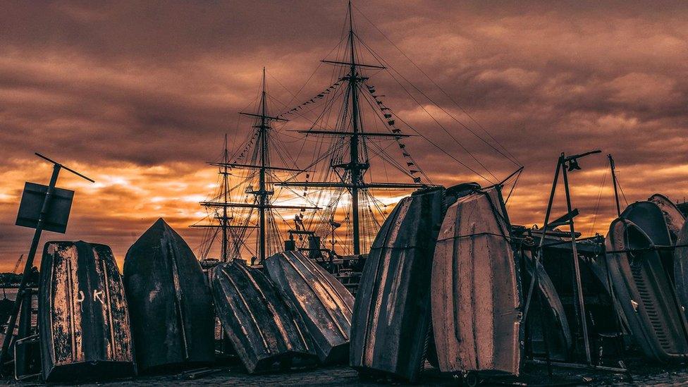 Numerous boats, and HMS Warrior in the background, at Portsmouth Harbour