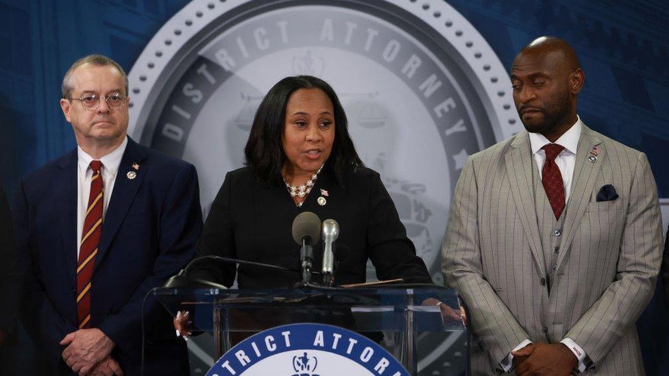 Fani Willis, center, and Nathan Wade, right, at a news conference in 2023.