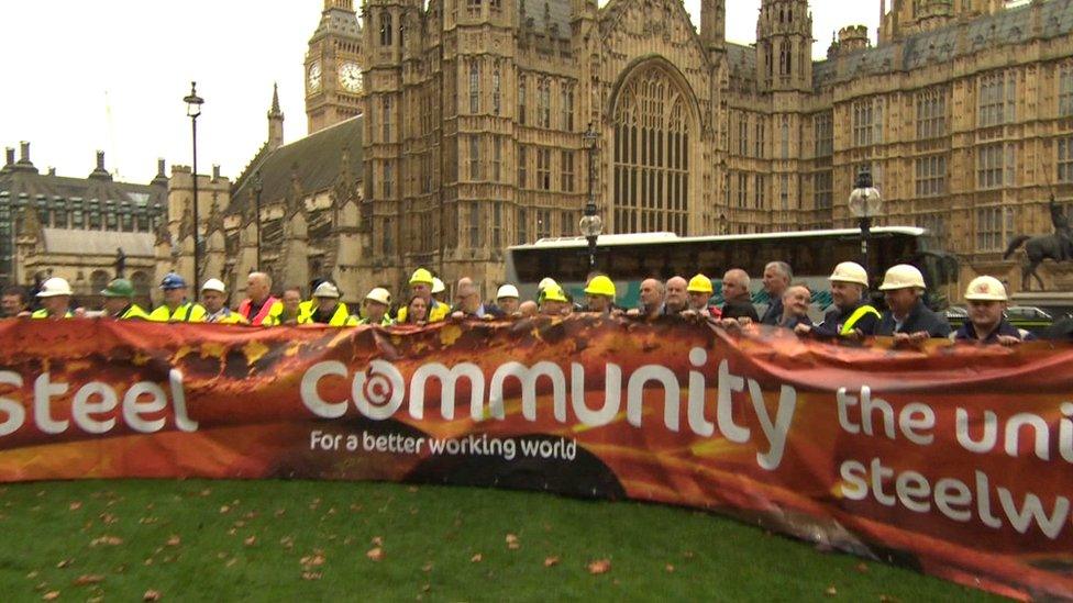 Dozens of steelworkers met outside Parliament to unfurl a Save Our Steel banner