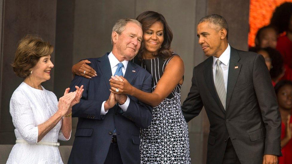 US First Lady Michelle Obama (C-R) hugs former President George W. Bush (C-L) while President Barack Obama (R) and former First Lady Laura Bush (L) look on at the opening of the Smithsonian's National Museum of African American History and Culture in Washington, DC, USA, 24 September 2016.