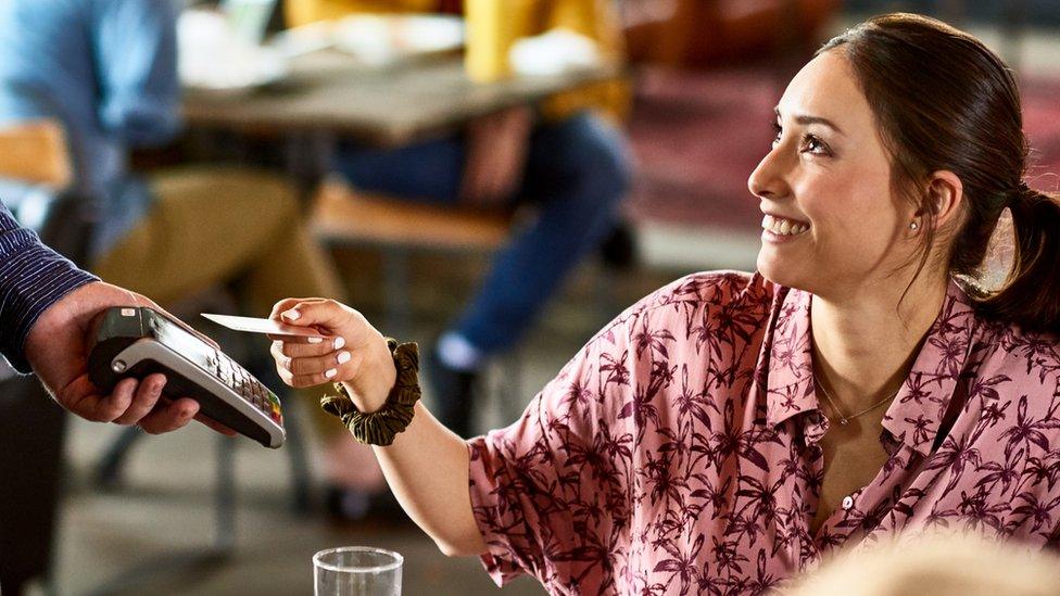 Woman paying for meal