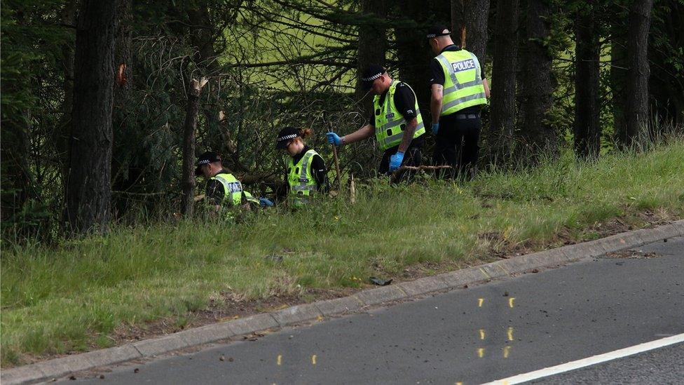 police searching at the scene of the crash