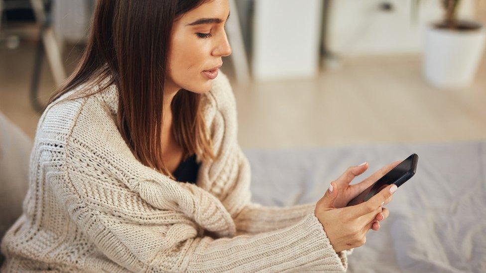 Woman looks at phone