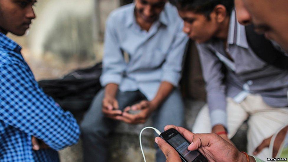 Young Indian boys with mobile phones