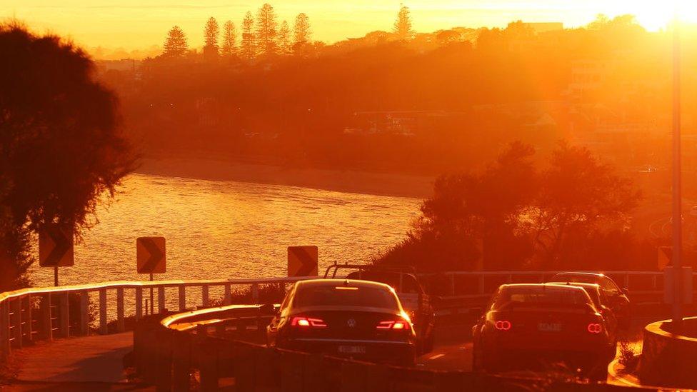 Peak hour traffic in Melbourne as the morning fog makes way for sunrise