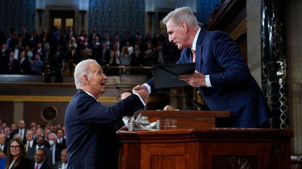 President Joe Biden shakes hands with House Speaker Kevin McCarthy