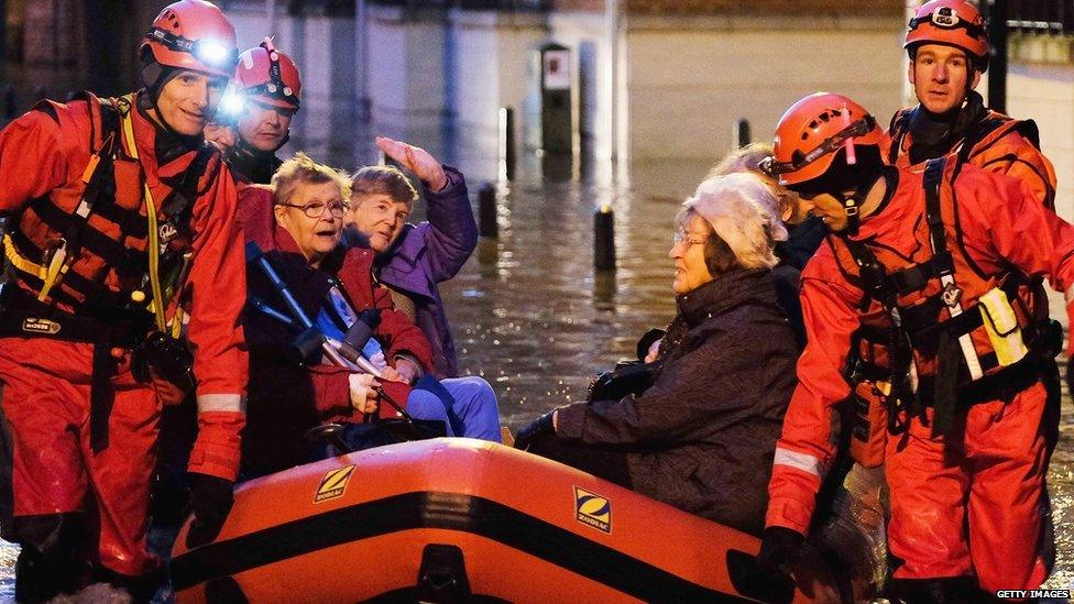 Members of Cleveland Mountain Rescue and soldiers from 2 Battalion The Duke of Lancasters Regiment assist members of the public as they are evacuated from the Queens Hotel in York city centre