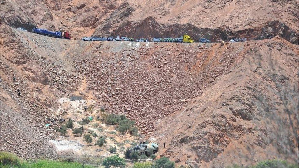 Rescue workers attend to the scene after a bus falls into a ravine in Arequipa, Peru February 21, 2018.