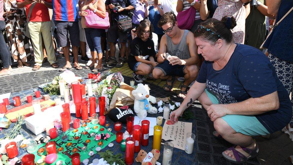 A woman looks at the tribute to victims of the attack on Las Ramblas