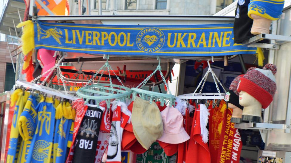 Unofficial Eurovision Song Contest scarves among Liverpool football and music souvenir scarves at a stall in Liverpool, 18 April 2023