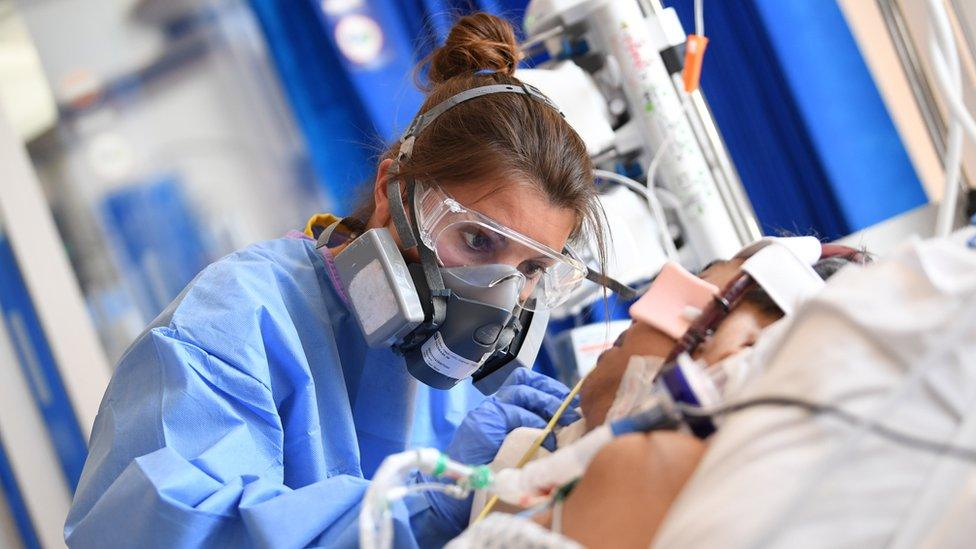 A medical worker wearing a protective face mask at the Royal Papworth Hospital in Cambridge