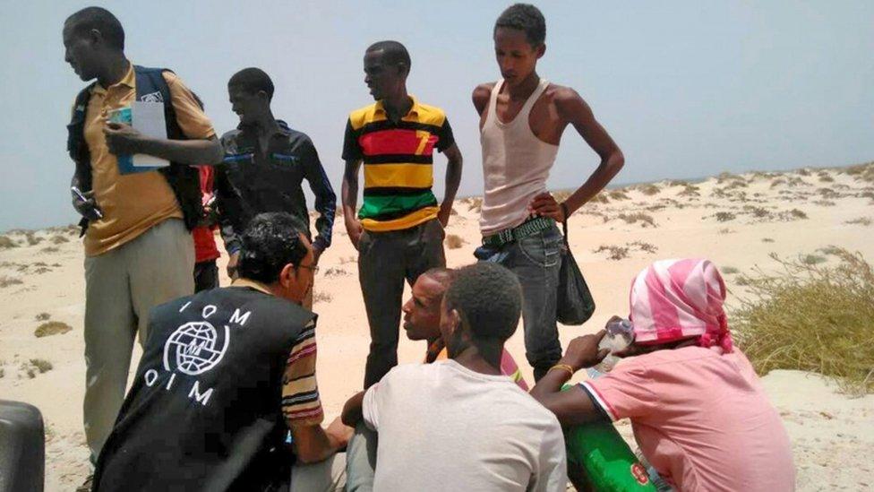 IOM staff members with migrants found on Shabwa beach, Yemen