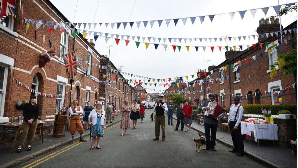 Residents of Cambrian Road dressed up in period costume take part in a street party to mark the 75th anniversary of VE Day in Chester on May 8, 2020