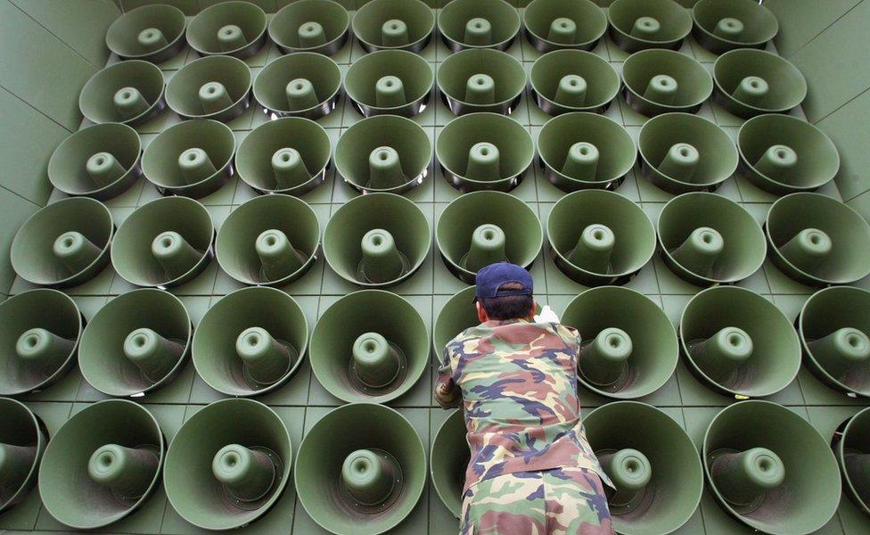 Man standing in front of a speaker stack