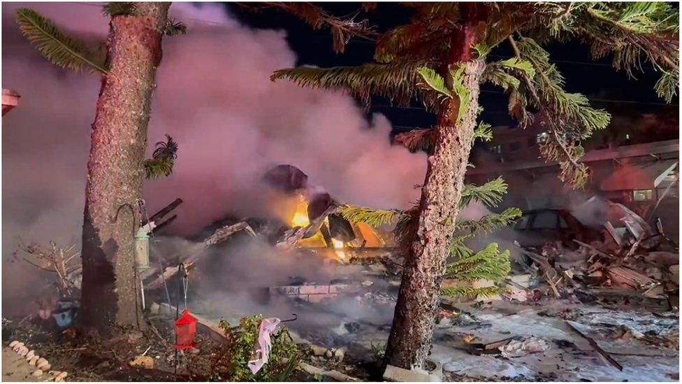 Video taken of the crash site shows fire and palm trees