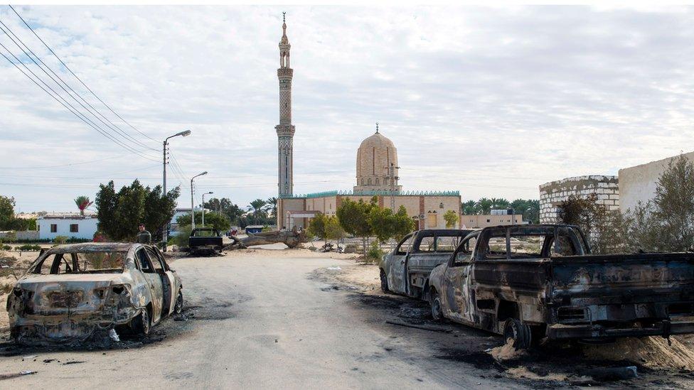 Burnt-out cars in the aftermath of the attack on Rawda mosque, 25 November 2017