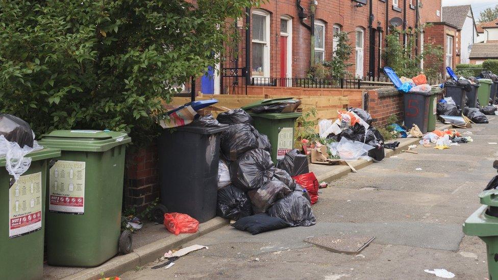 A file image of a litter-strewn street in Hyde Park, Leeds