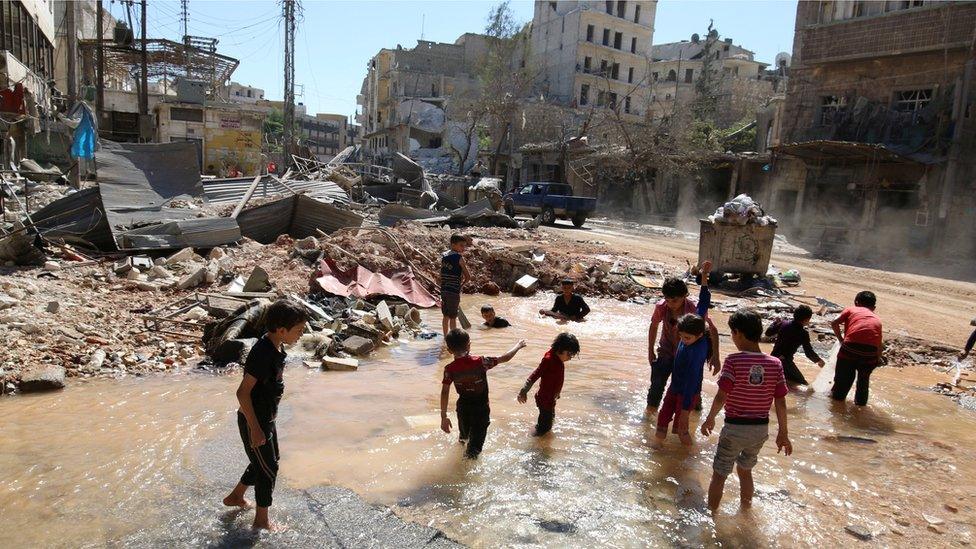 Children play with water from a burst water pipe at a site hit yesterday by an air strike in Aleppo"s rebel-controlled al-Mashad neighbourhood, Syria, September 30, 2016.