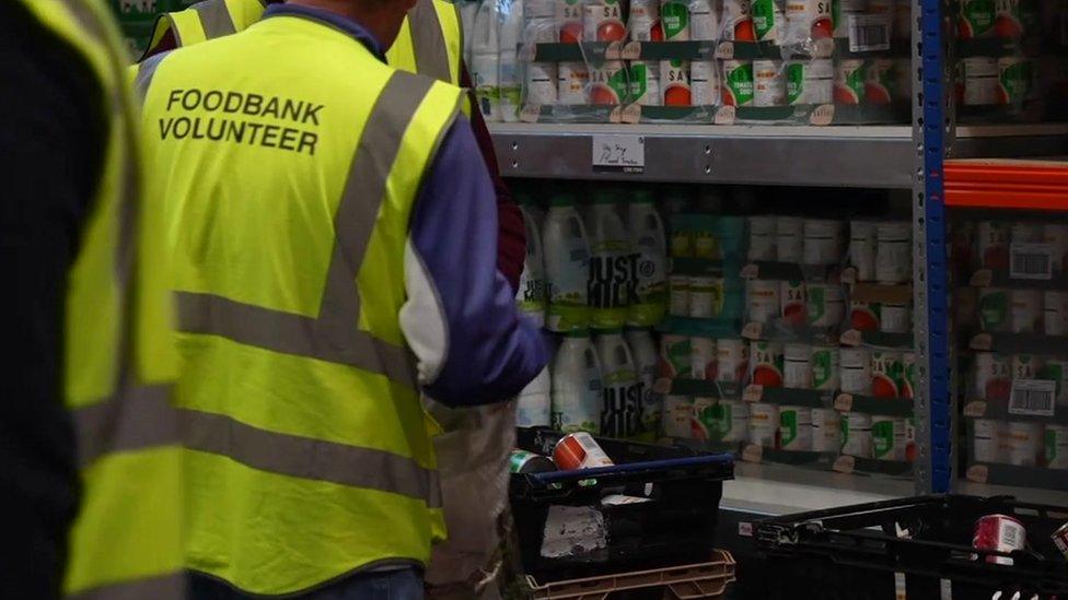 Image of foodbank workers loading food into a bag