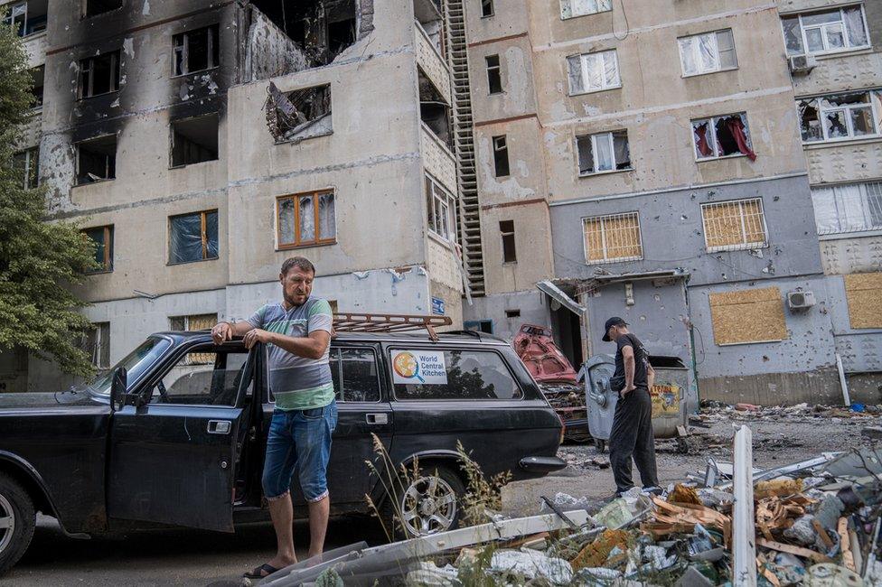 Food delivery volunteer Leon Petrosyan smokes a cigarette. "The people here have nowhere else to go," he said. "They are trapped"