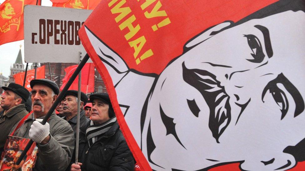 Russian communist party supporter with Stalin flag