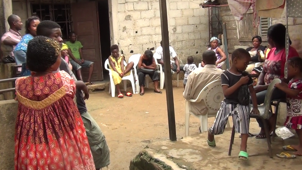 Mourners at Monique Koumateke's house in Douala, Cameroon