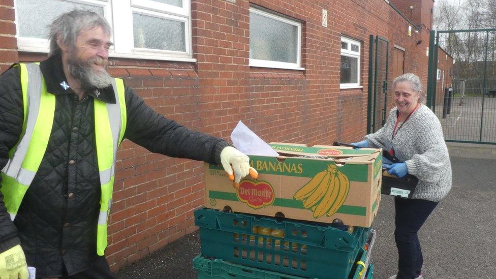 Frank delivering food to Lisa Hutchinson at St Anne' RC Primary