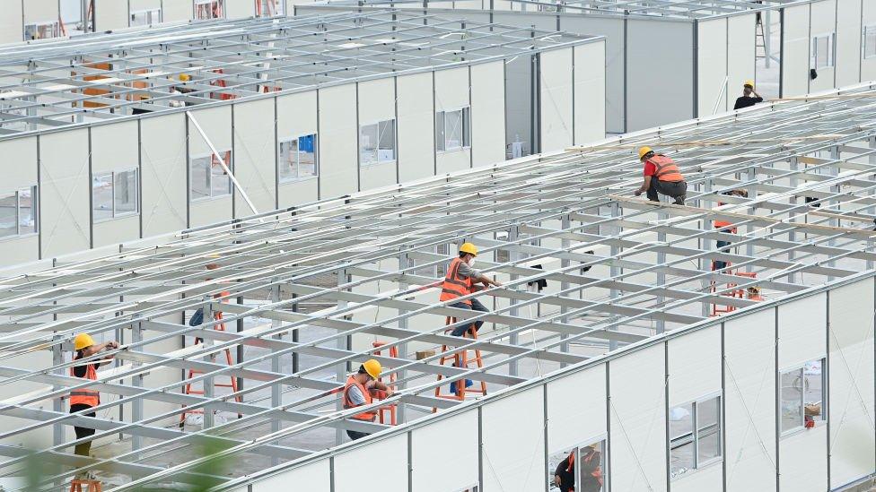 Workers build a makeshift hospital for COVID-19 patients on November 22, 2022 in Chongqing, China.