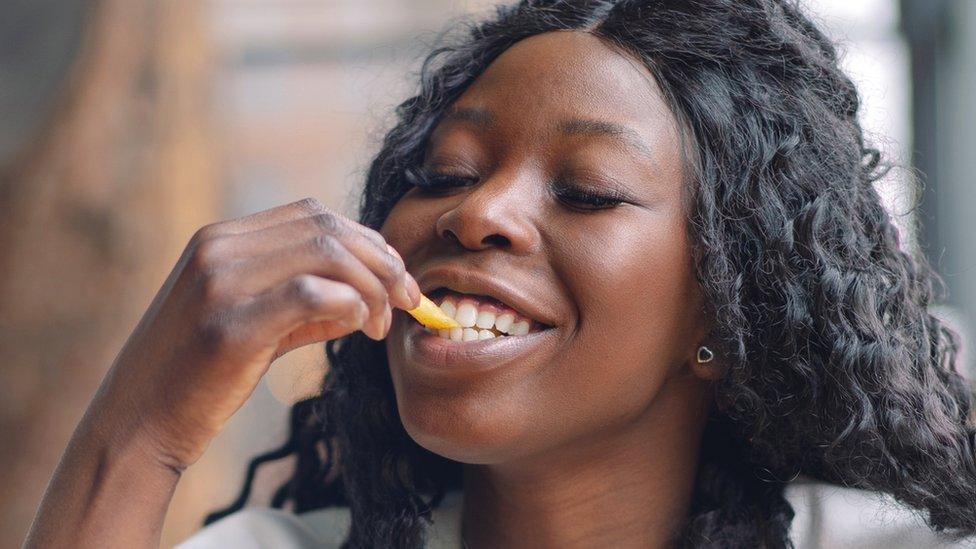 Woman eating a chip