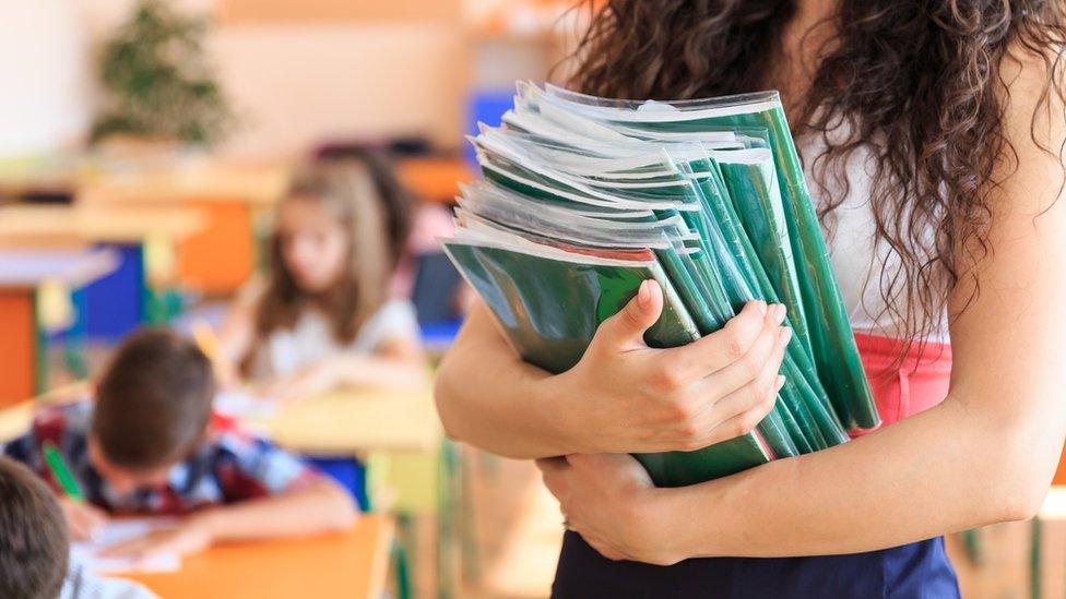 Teacher holding books