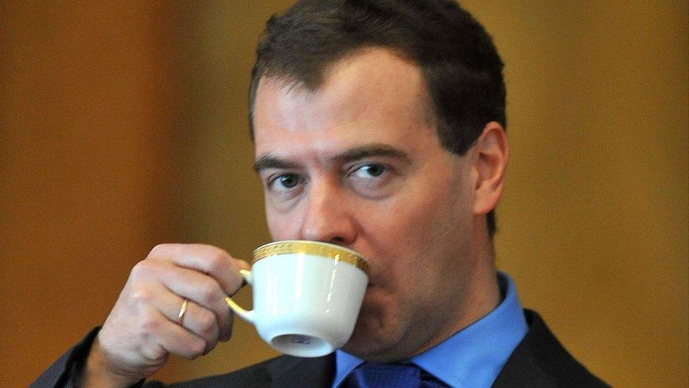 Dmitry Medvedev drinking from a coffee cup