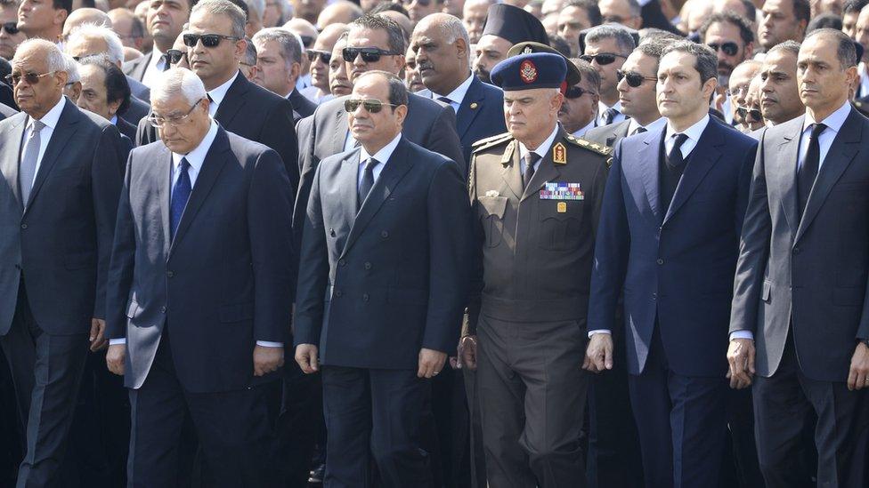 President Abdul Fattah al-Sisi (C) stands near Hosni Mubarak's sons Alaa (2nd R) and Gamal (R), at a funeral in Cairo (26 February 2020)