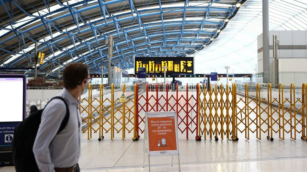 A commuter walking past a closed concourse inside Waterloo Station during the national rail strikes