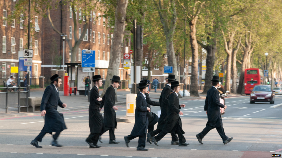 Ultra-Orthodox men walking across a road in London