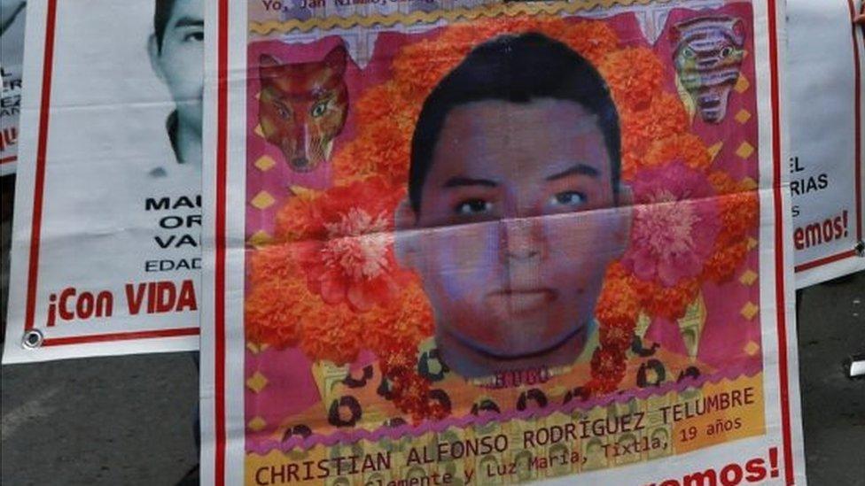 In this file photo taken on September 26, 2019 people protest in Mexico City to mark five years of the disappearance of the 43 students of the teaching training school in Ayotzinapa