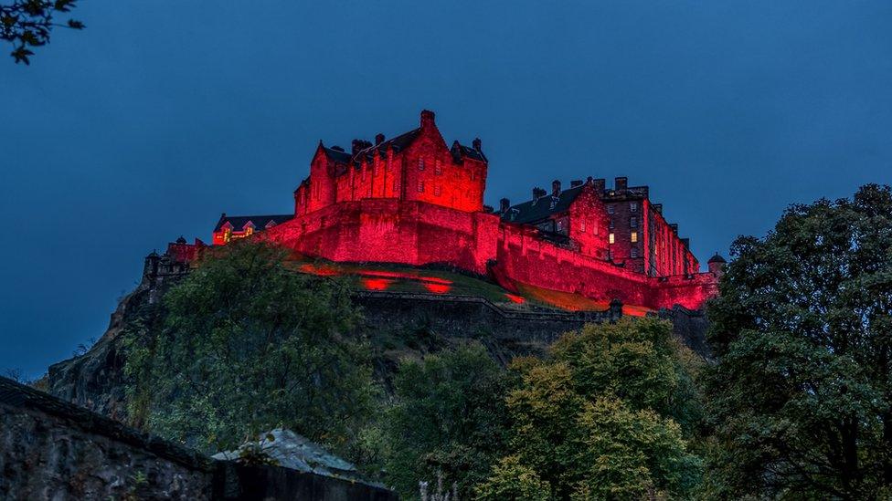 Edinburgh Castle lit up red for Armistice day taken by Alan Pottinger in the grounds of St Cuthbert's church.