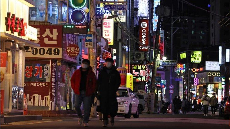 Cafes, restaurants and karaoke rooms are open late at night on a street in Seoul, South Korea, 15 February 2021