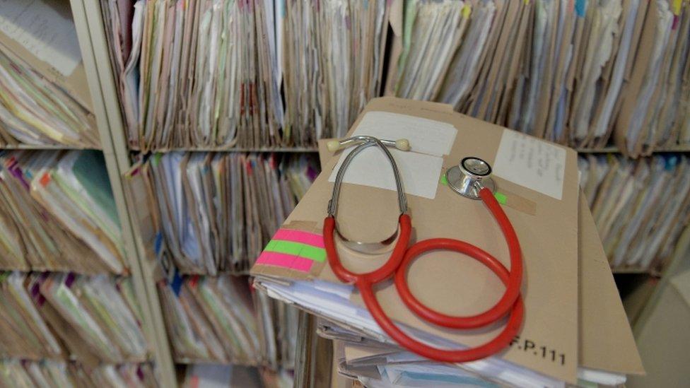 Stethoscope on top of patient files in surgery