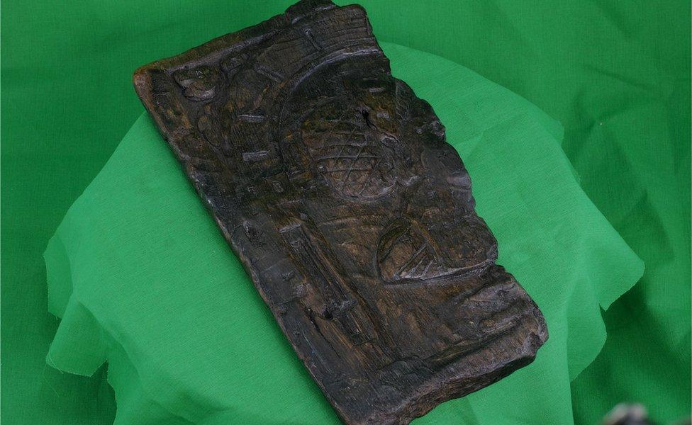 wooden panel on green cloth